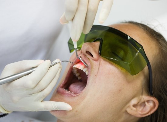 Patient receiving laser periodontal therapy