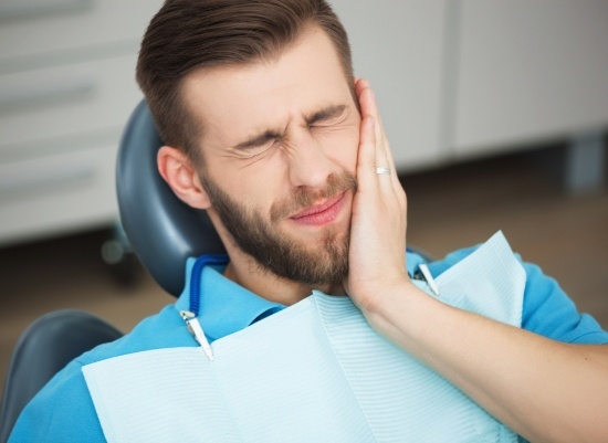 Man in need of soft tissue grafting experiencing tooth sensitivity