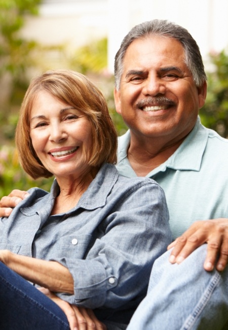 Man and woman smiling after antibiotic therapy for gum disease