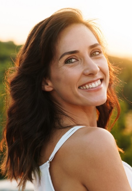 Woman sharing healthy smile after periodontal disease treatment