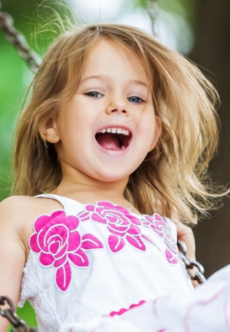 Little girl with healthy smile after children's dentistry