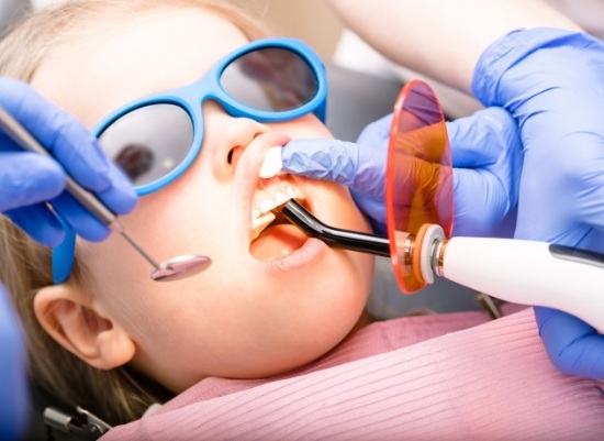 Child receiving dental sealants