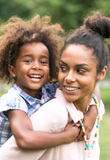 Mother and child sharing healthy smiles after dental checkup and teeth cleaning