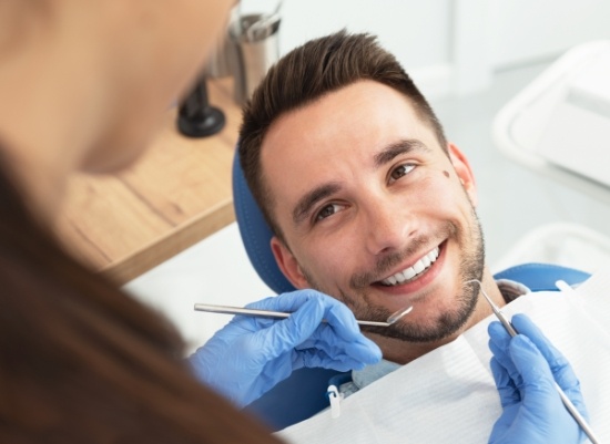 Man smiling during dental checkup and teeth cleaning