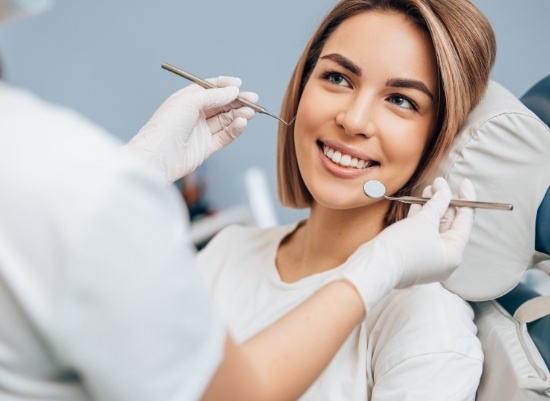 Woman smiling during a refreshing dental hygiene visit