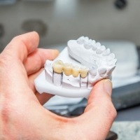 Lab technician crafting a dental bridge restoration