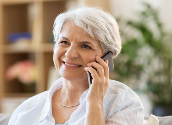 Woman calling to schedule a visit with our dentist