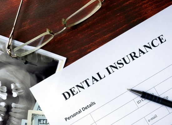 A dental insurance form on a wooden table