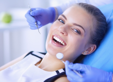 Woman smiling during dental treatment