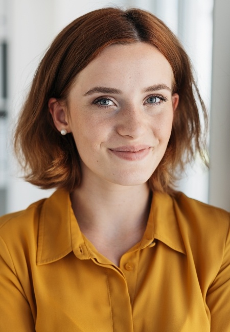 Woman smiling after emergency dentistry