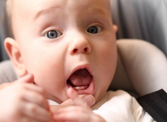 Dentist examining baby before a frenectomy