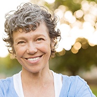 woman smiling after getting dental implants in Houston