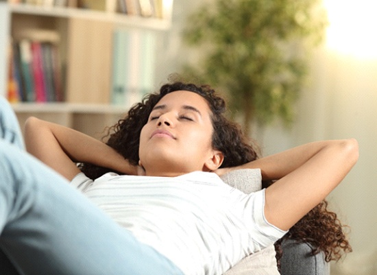 Woman resting after getting a dental implant in Houston