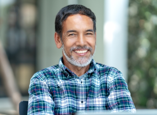 Smiling man enjoying the benefits of dental implants