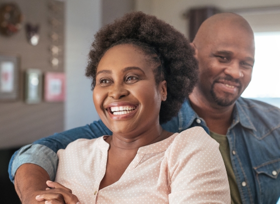 Man and woman enjoying the benefits of dental implant tooth replacement