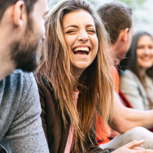 Woman laughing with group of friends