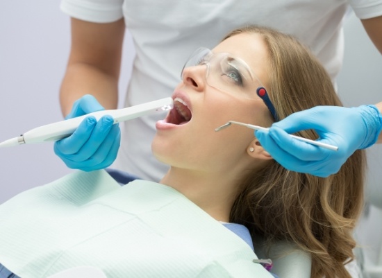 Dentist using intraoral camera to capture images