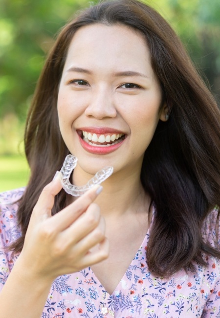 Woman placing an Invisalign tray