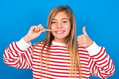 Pleased teen shows off clear aligners