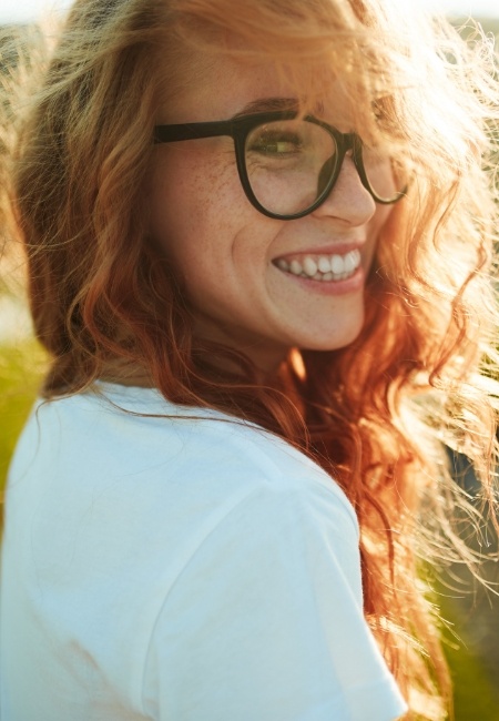 Woman with gorgeous smile after Lumineers treatment