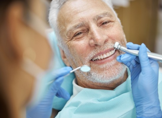 Dentist providing treatment to patient with diabetes and osteoporosis