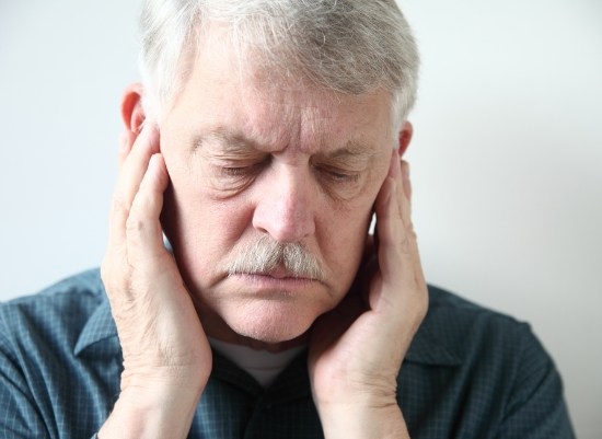 Man experiencing jaw pain before occlusal adjustment