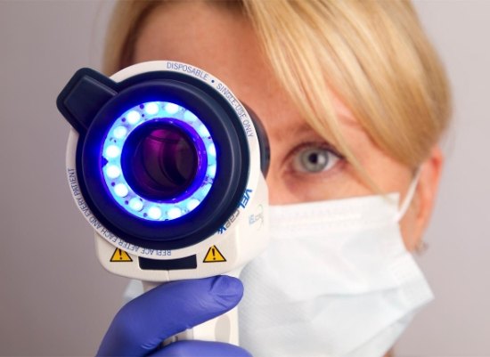 Dentist performing oral cancer screening