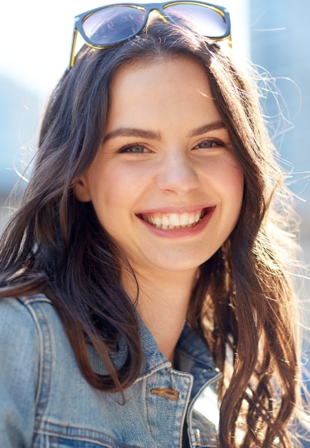 Woman with perfectly aligned smile after orthodontic treatment