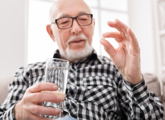 Man taking a pain pill after root canal therapy