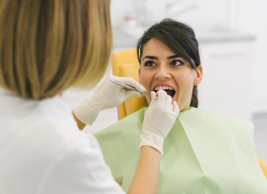 Woman receiving dental checkup and teeth cleaning