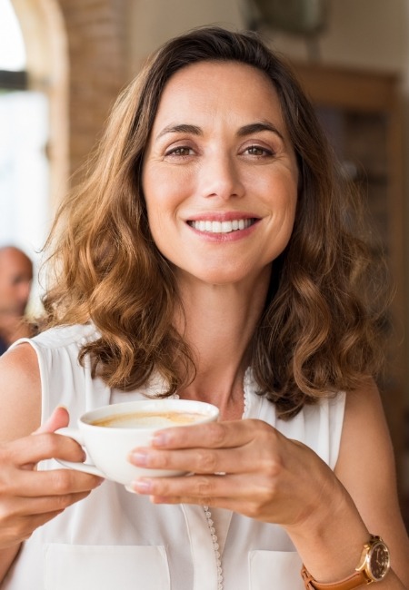 Woman sharing healthy smile after scaling and root planing