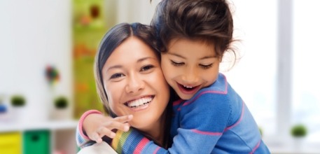 Mother hugging child after children's dentistry visit