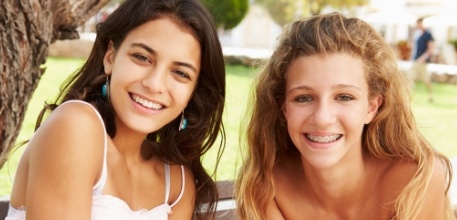 Teens smiling during orthodontic treatment