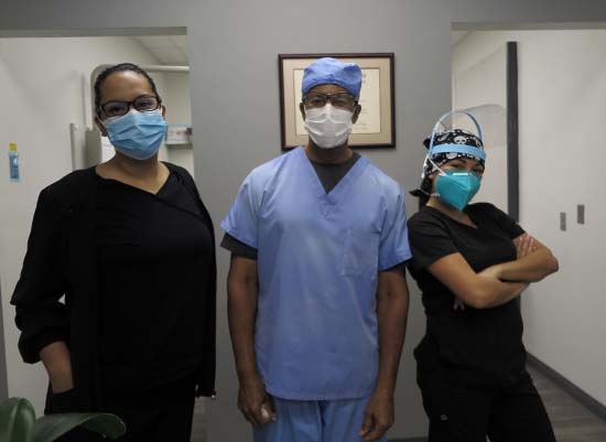 Three friendly dental team members