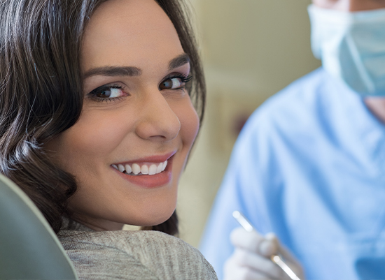 Woman smiling during dental services