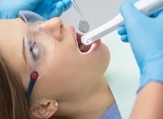 Dentist using intraoral camera to capture images