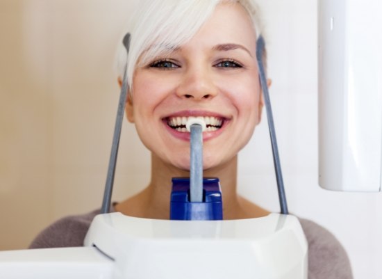 Woman receiving 3 D cone beam imaging