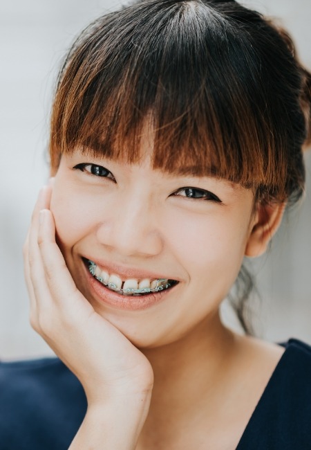 woman with traditional orthodontics smiling