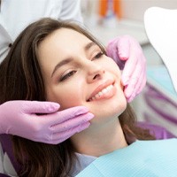 patient smiling while getting cosmetic dentistry in Houston