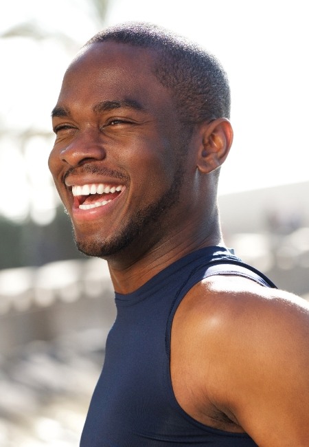 Man with flawless smile after porcelain veneer treatment