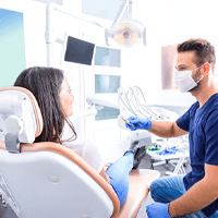 a dentist examining a patient’s mouth