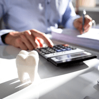 a person using a calculator while sitting at a desk