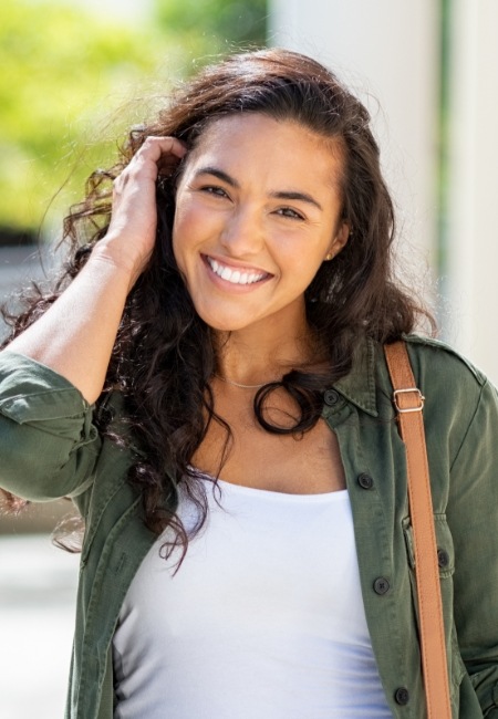 Young woman smiling after wisdom tooth extractions