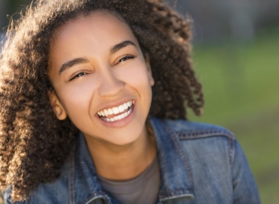 Teen girl smiling after wisdom tooth extraction