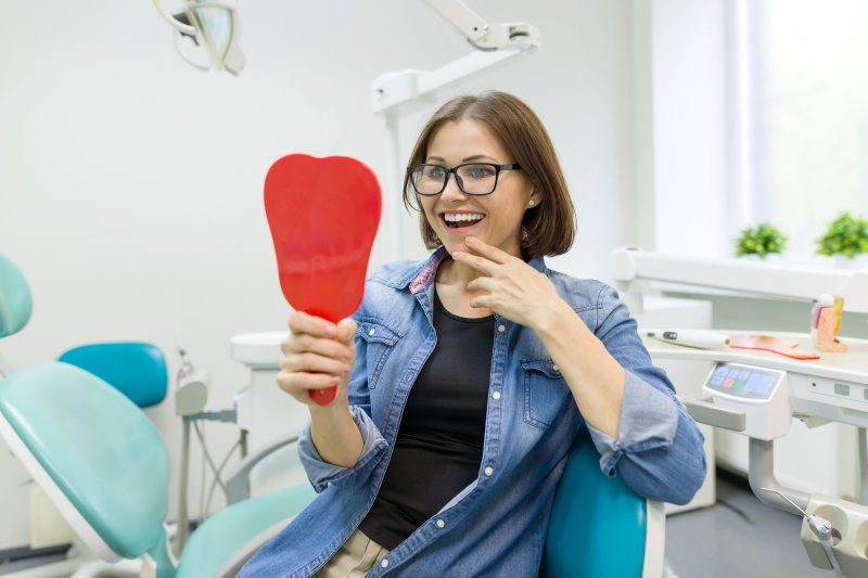 a woman in pain at the dentist office