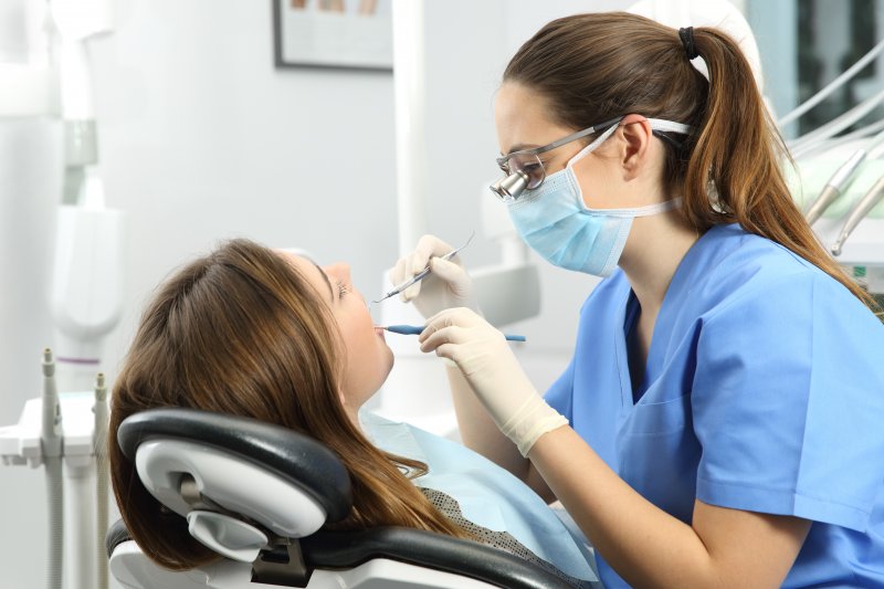 dental hygienist working on patient