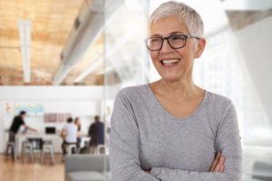 smiling woman with dental implants in an office 