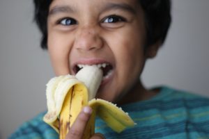 boy eating banana 