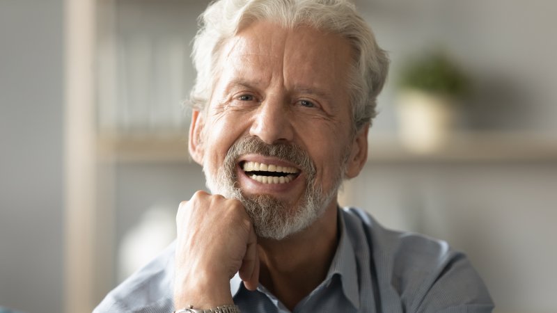 A man smiling with his dentures